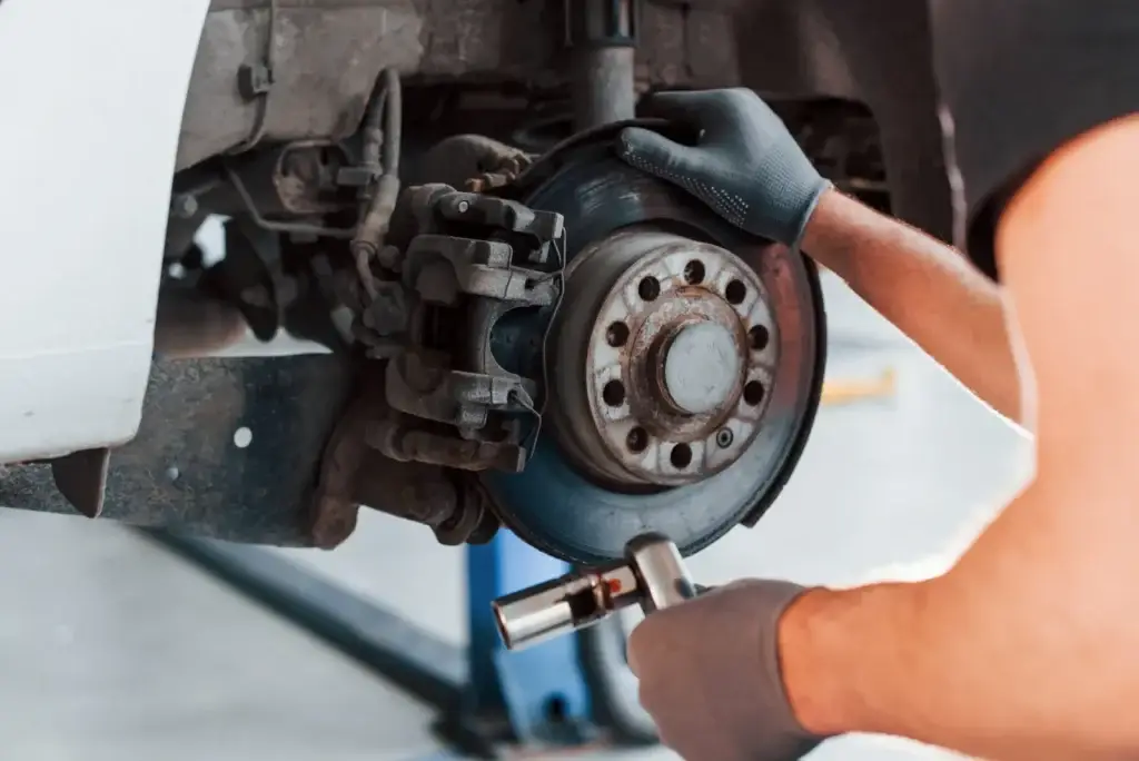 Mechanic fitting a brake disc and caliper
